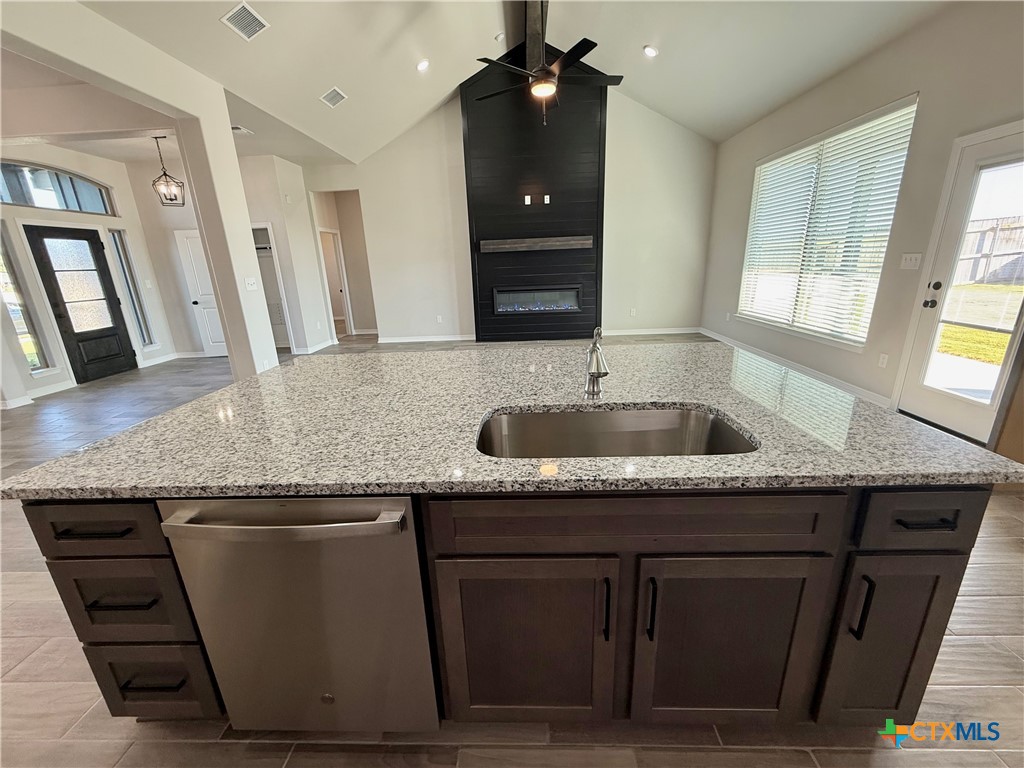 4433 Agave Trail Temple, TX 76502 - Photo 11 of 27 a kitchen with granite countertop a sink and a toilet