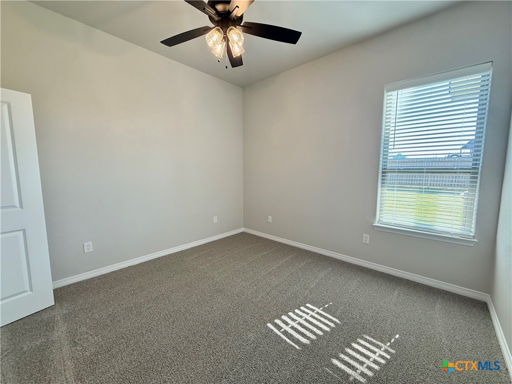 4433 Agave Trail Temple, TX 76502 - Photo 13 of 27 an empty room with a window and ceiling fan
