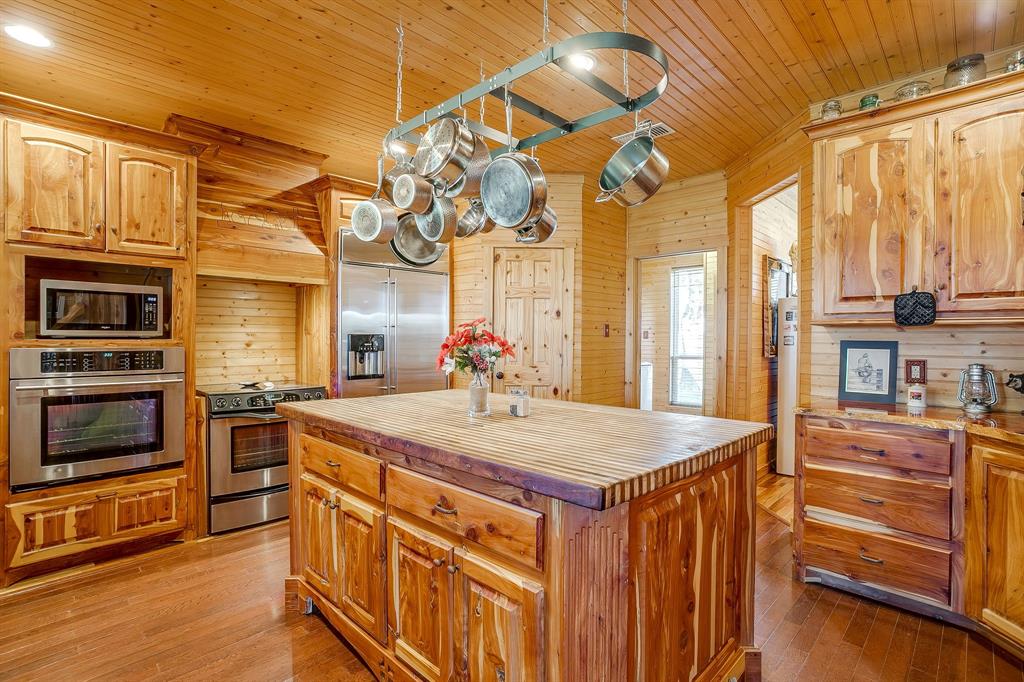 1791 Farm To Market Road 730 North Decatur, TX 76234 - Photo 21 of 40 a kitchen with stainless steel appliances granite countertop a sink a stove and cabinets