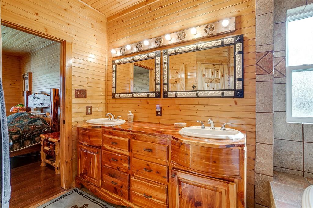 1791 Farm To Market Road 730 North Decatur, TX 76234 - Photo 26 of 40 a bathroom with a double vanity sink and a mirror