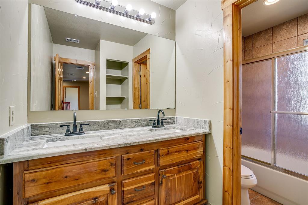 1791 Farm To Market Road 730 North Decatur, TX 76234 - Photo 31 of 40 a bathroom with a granite countertop sink and a mirror