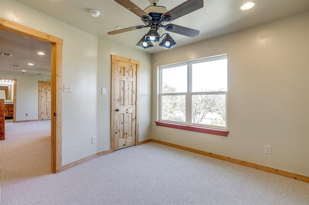1791 Farm To Market Road 730 North Decatur, TX 76234 - Photo 35 of 40 en empty room with windows and ceiling fan