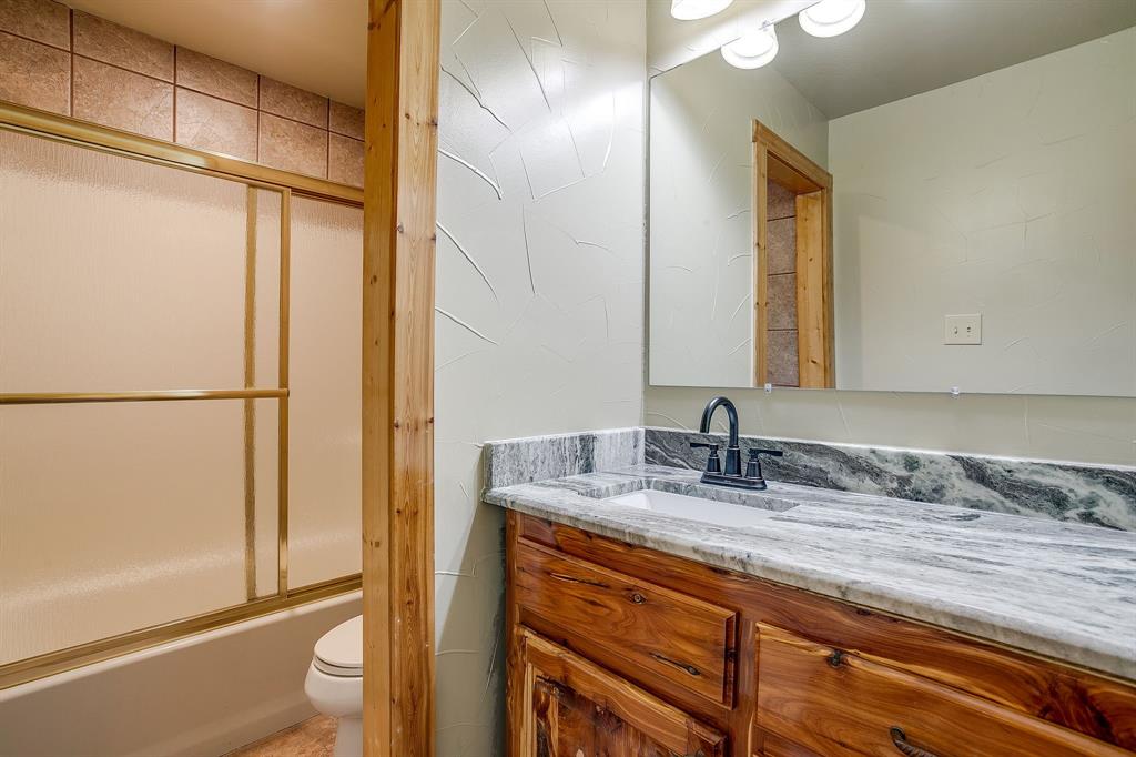 1791 Farm To Market Road 730 North Decatur, TX 76234 - Photo 36 of 40 a bathroom with a granite countertop sink and a mirror