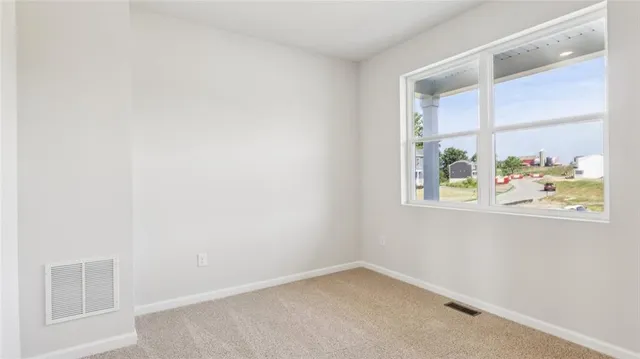 a large kitchen with a large window and stainless steel appliances