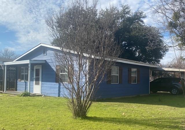 a front view of a house with yard and green space