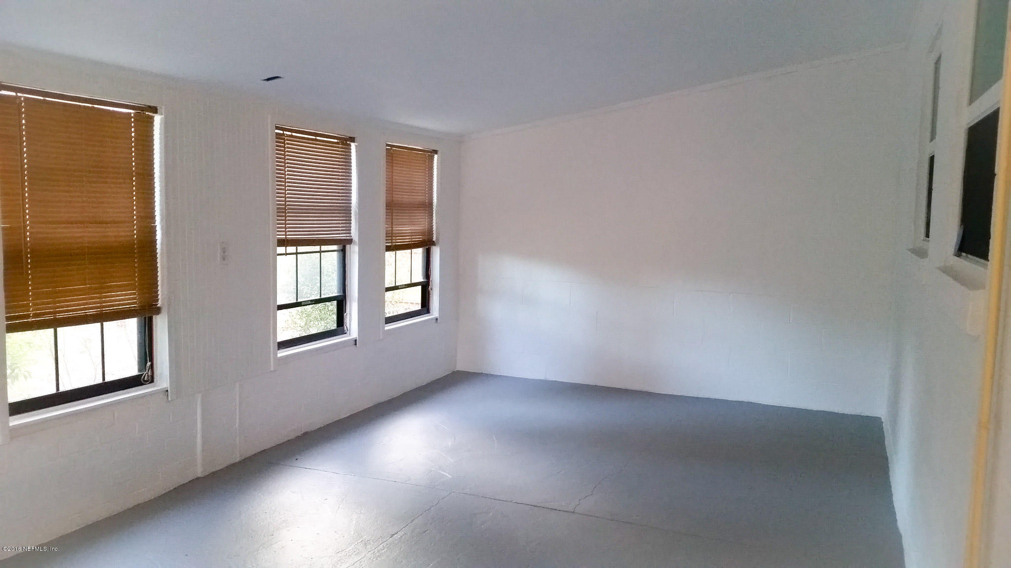 748 Vecuna Road Atlantic Beach, FL 32233 - Photo 16 of 33 an empty room with windows