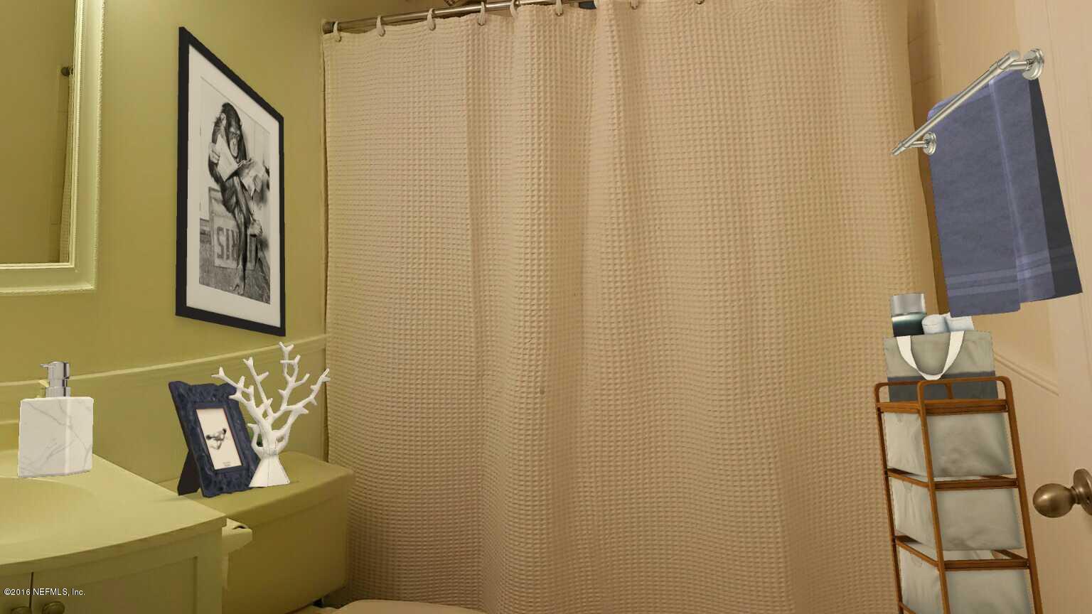 748 Vecuna Road Atlantic Beach, FL 32233 - Photo 19 of 33 a bathroom with a sink and mirror