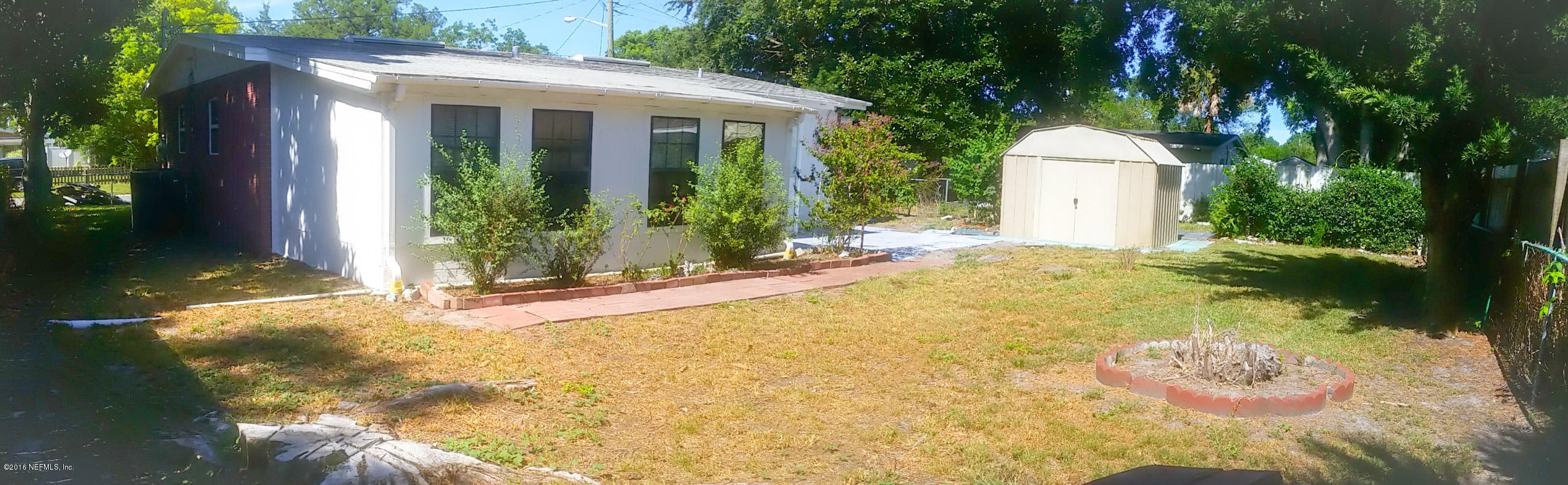 748 Vecuna Road Atlantic Beach, FL 32233 - Photo 29 of 33 a view of a white house with a small yard and plants