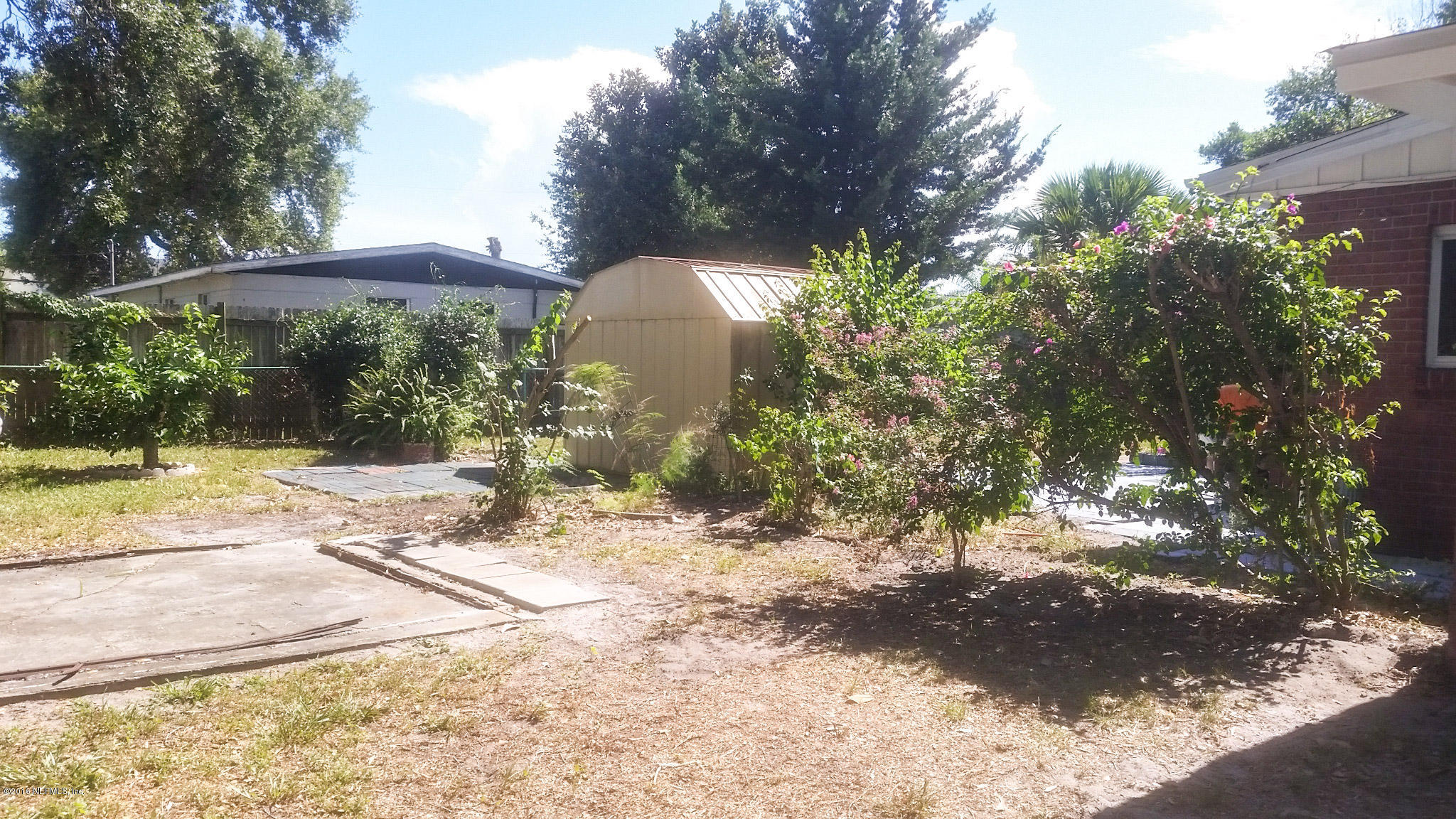 748 Vecuna Road Atlantic Beach, FL 32233 - Photo 30 of 33 a view of a yard with plants and a bench