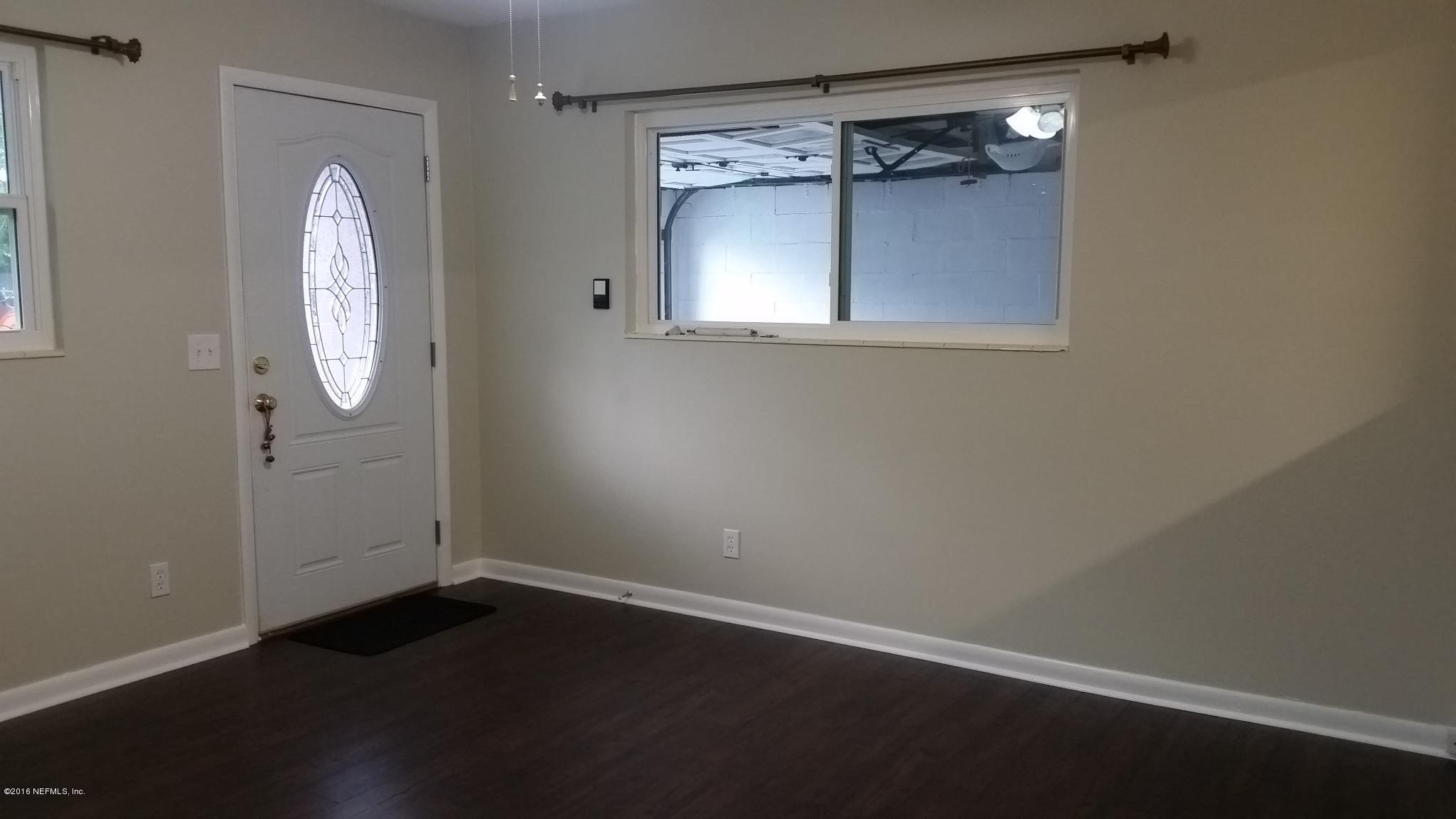 748 Vecuna Road Atlantic Beach, FL 32233 - Photo 5 of 33 an empty room with wooden floor and a window