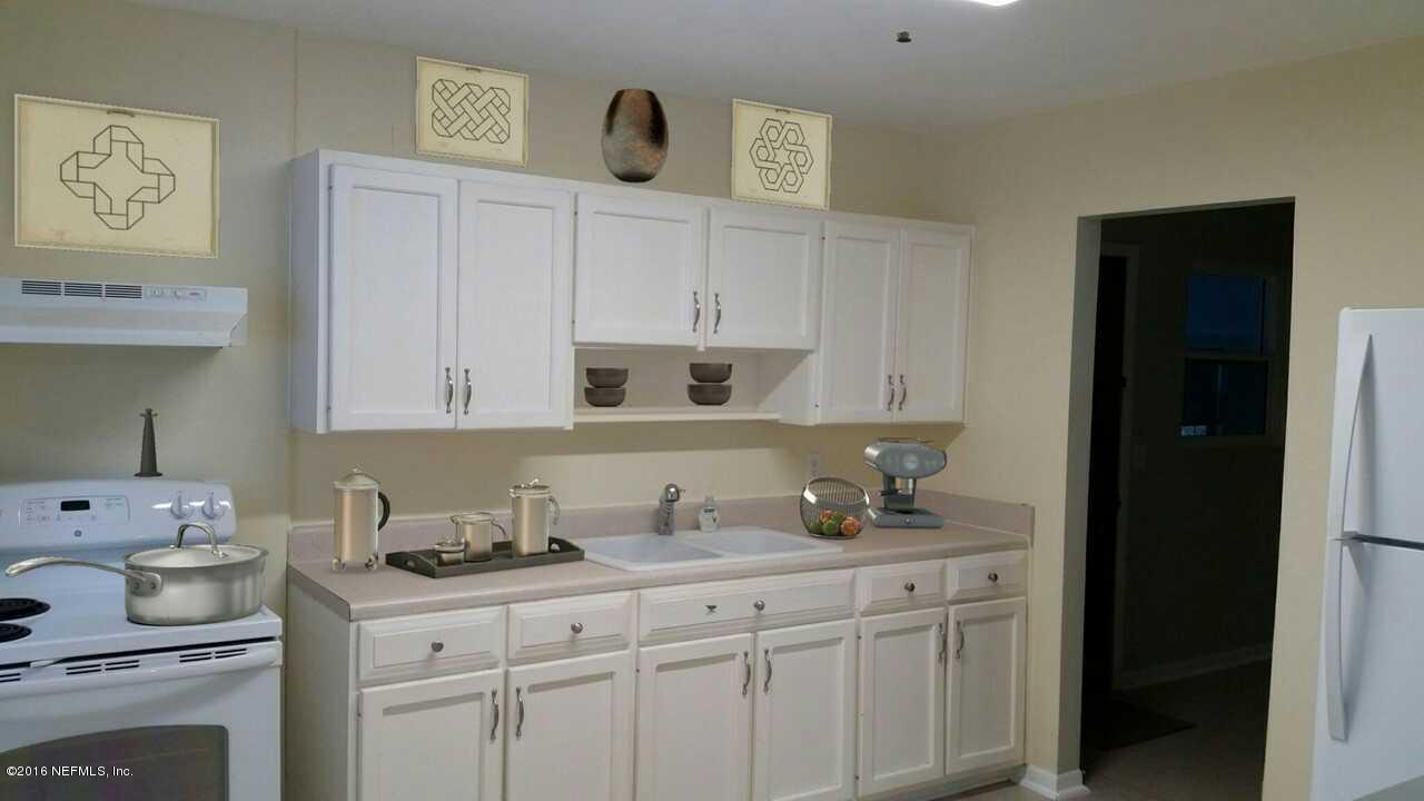 748 Vecuna Road Atlantic Beach, FL 32233 - Photo 9 of 33 a kitchen with granite countertop white cabinets and white appliances