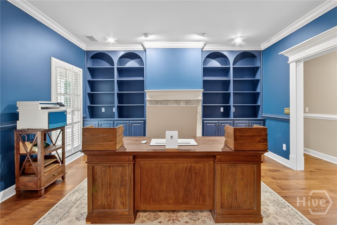 101 Red Bluff Run Rincon, GA 31326 - Photo 14 of 45 Office/formal living space with cased opening and gas fireplace with logs in place between built in bookshelves