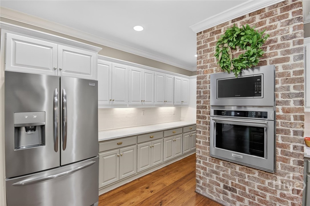 101 Red Bluff Run Rincon, GA 31326 - Photo 15 of 45 Kitchen hallway has double door pantry and wine shelving walking into formal dining room