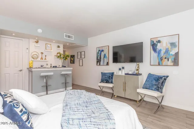 a bedroom with a bed and a flat screen tv