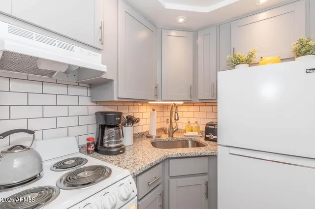 a kitchen with a refrigerator and a sink