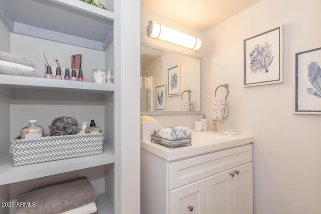 a bathroom with a sink cabinets and toilet