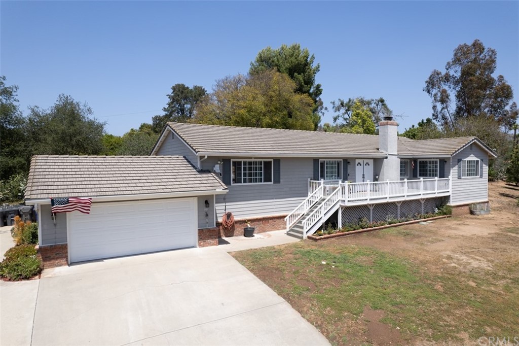 a front view of a house with a wooden deck
