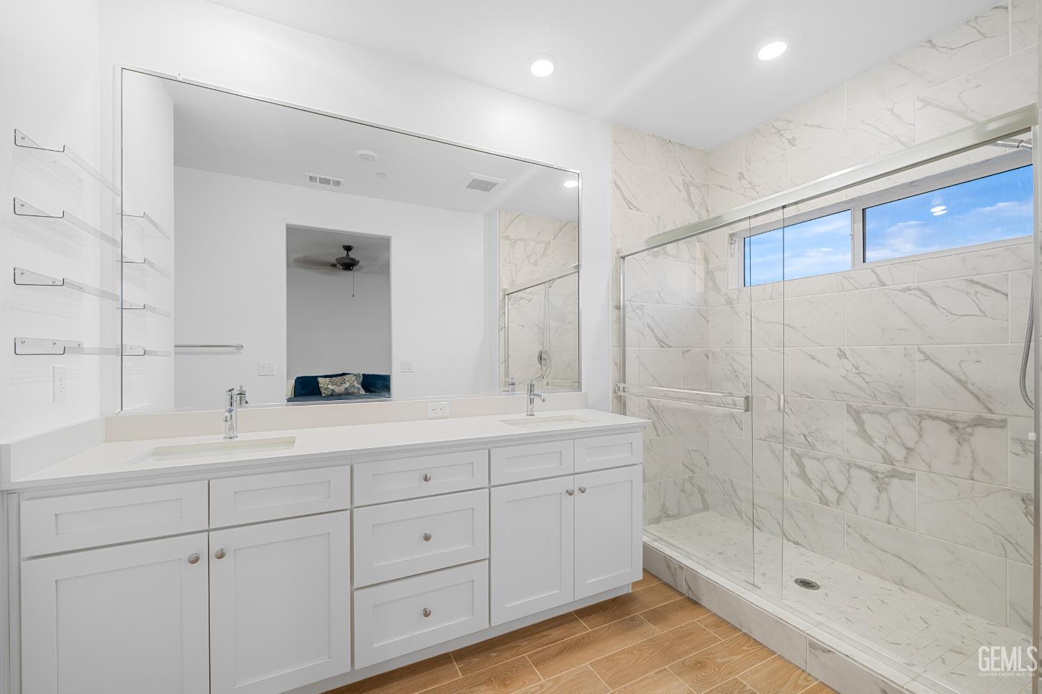 Undisclosed Address Shafter, CA 93263 - Photo 31 of 40 a bathroom with a double vanity sink a large mirror and shower
