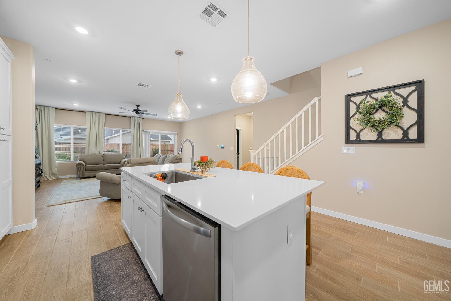 Undisclosed Address Shafter, CA 93263 - Photo 4 of 40 a room with kitchen island a sink and a stove with wooden floor