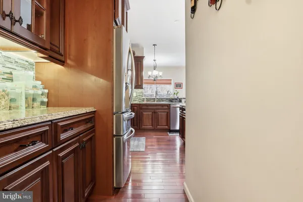 a kitchen with wooden cabinets and stainless steel appliances