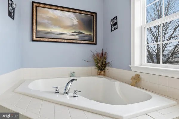 a bathroom with a tub and a sink