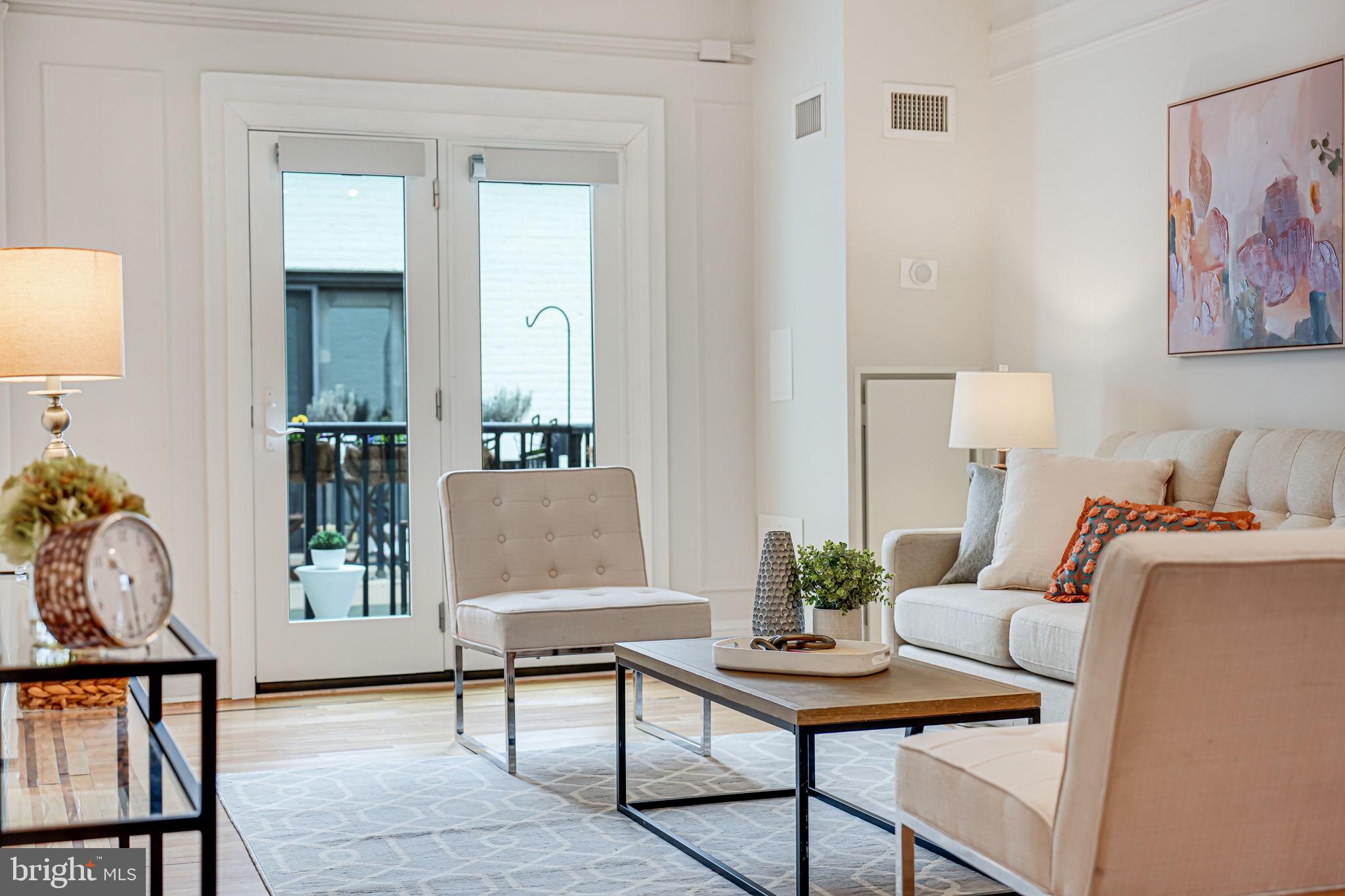 1613 Harvard Street Northwest, Unit 515 Washington, DC 20009 - Photo 11 of 53 a living room with furniture and a potted plant