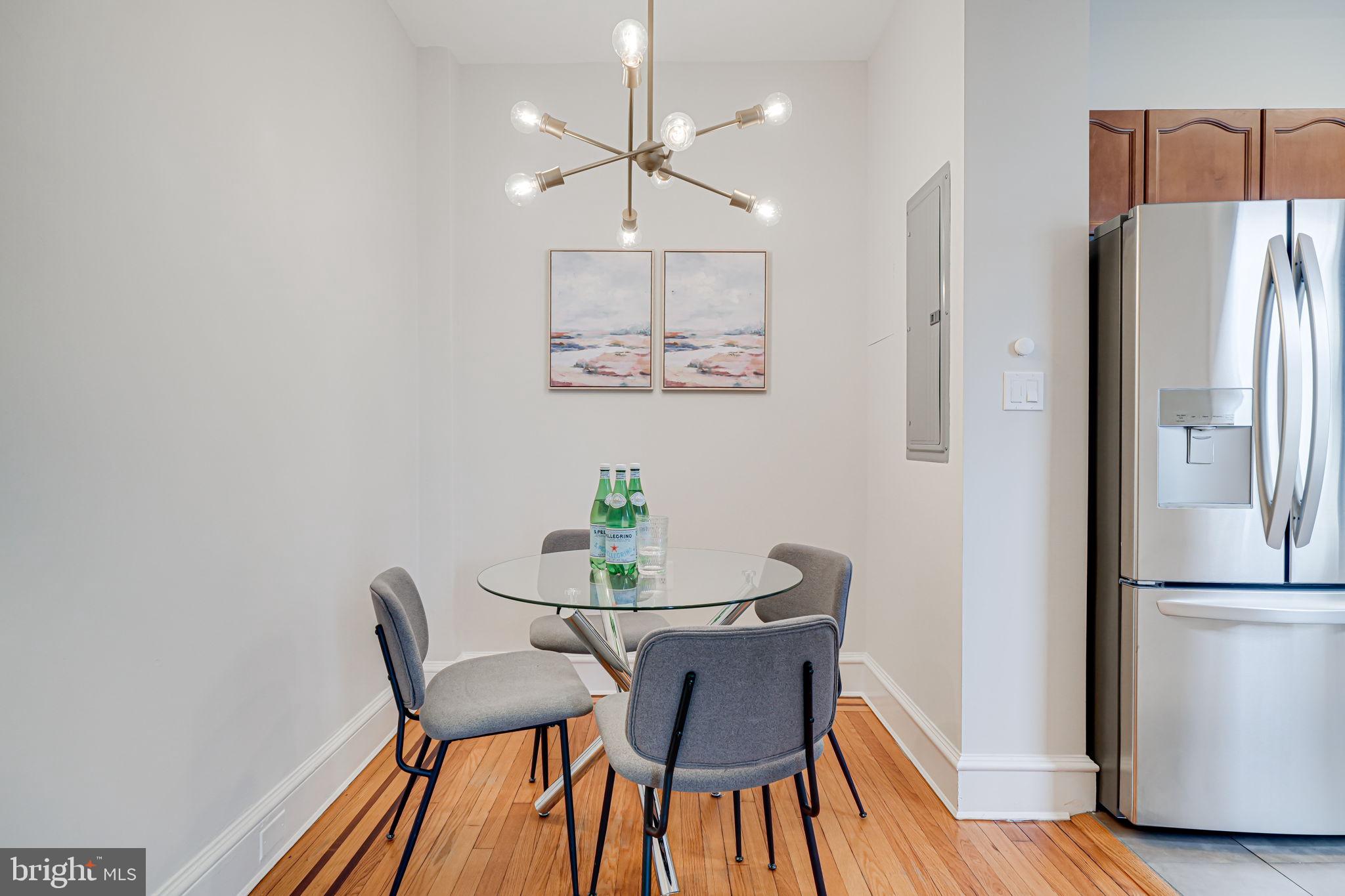 1613 Harvard Street Northwest, Unit 515 Washington, DC 20009 - Photo 15 of 53 a view of a dining room with furniture and wooden floor