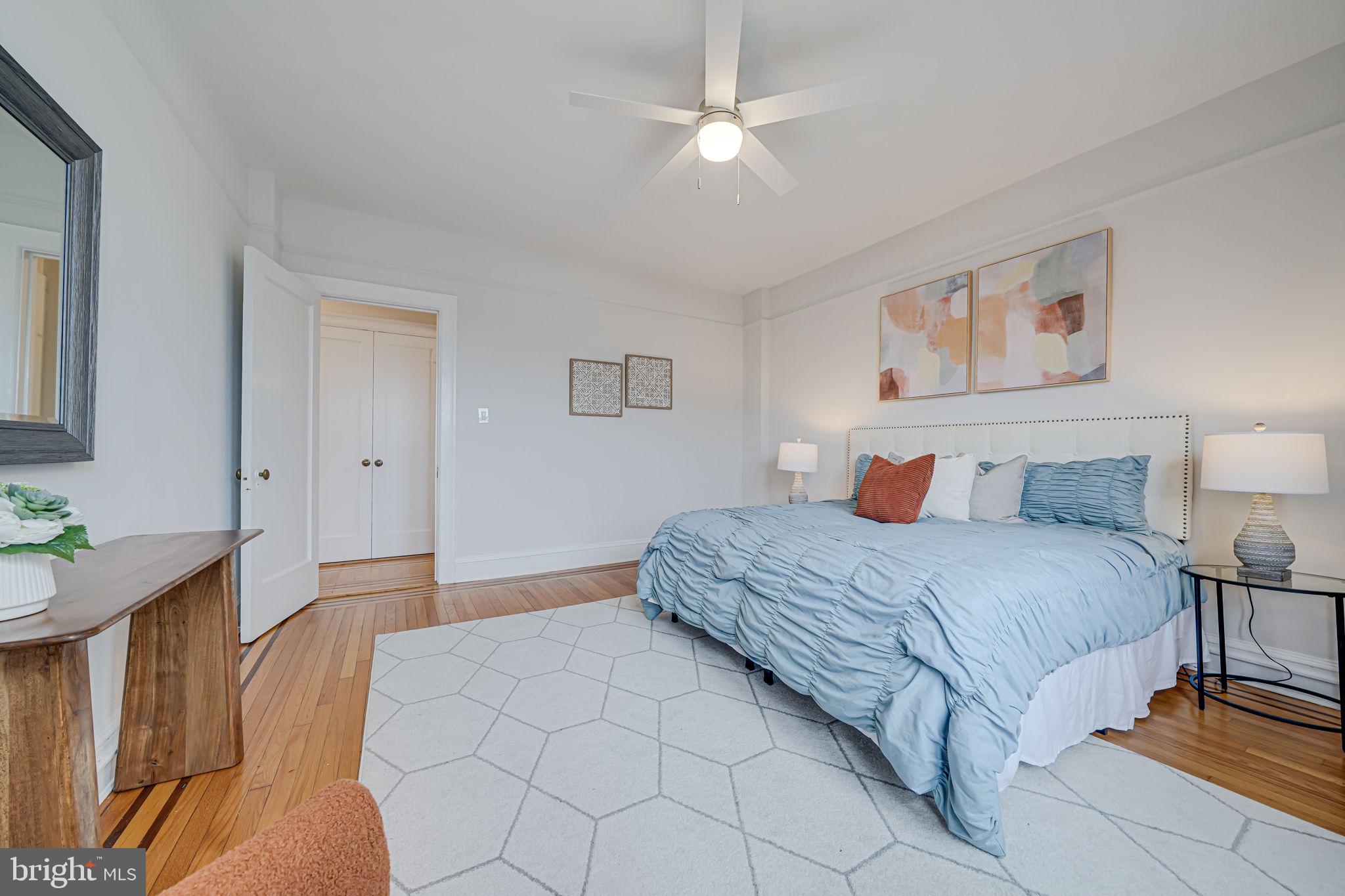1613 Harvard Street Northwest, Unit 515 Washington, DC 20009 - Photo 33 of 53 a bedroom with a large bed and a chandelier