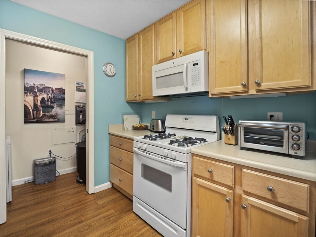 36 Village Road, Unit 614 Middleton, MA 01949 - Photo 8 of 34 a kitchen with stainless steel appliances white cabinets and a stove top oven