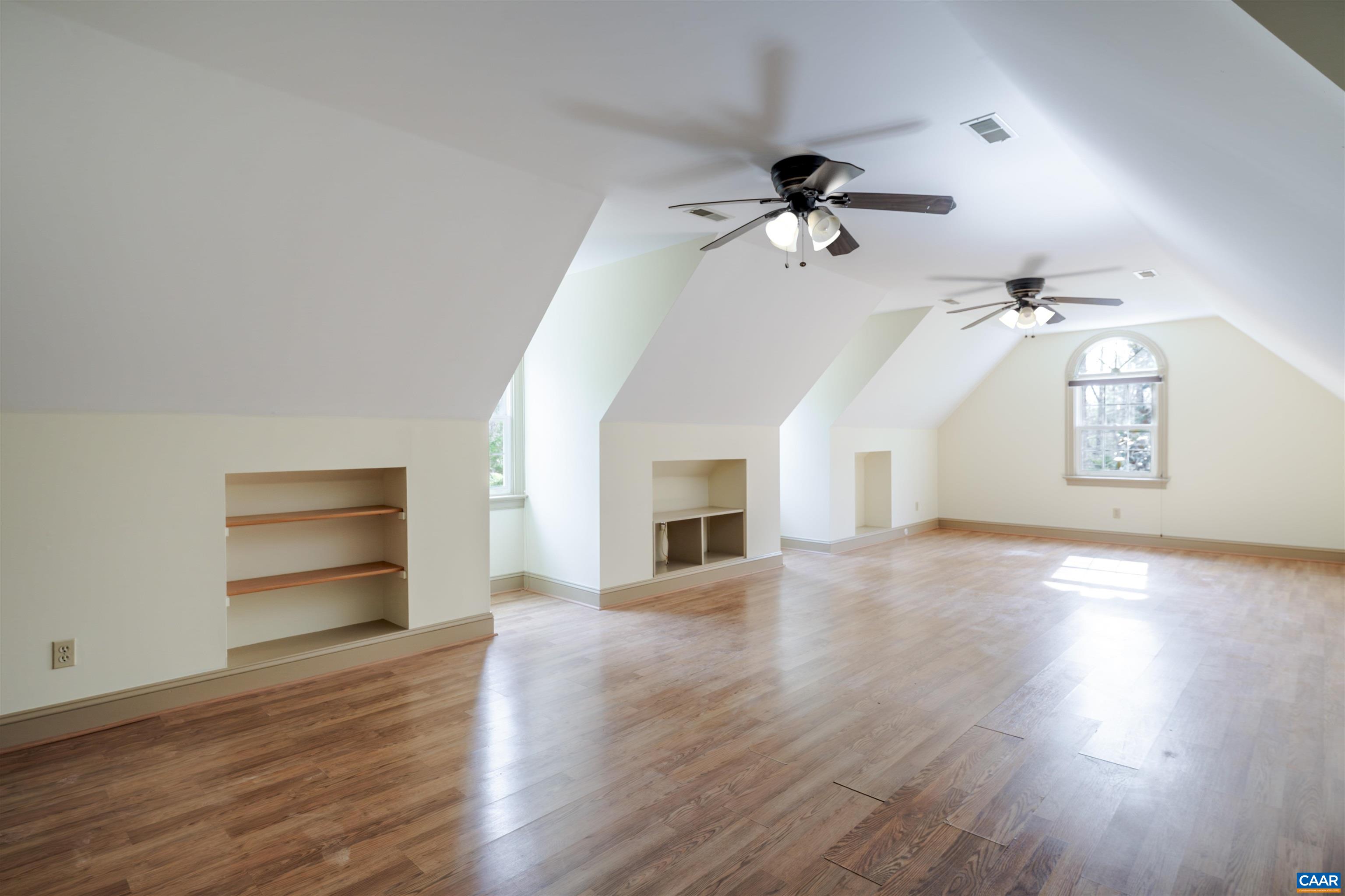 3125 Beau Mont Farm Road Charlottesville, VA 22901 - Photo 51 of 74 an empty room with wooden floor fireplace and windows