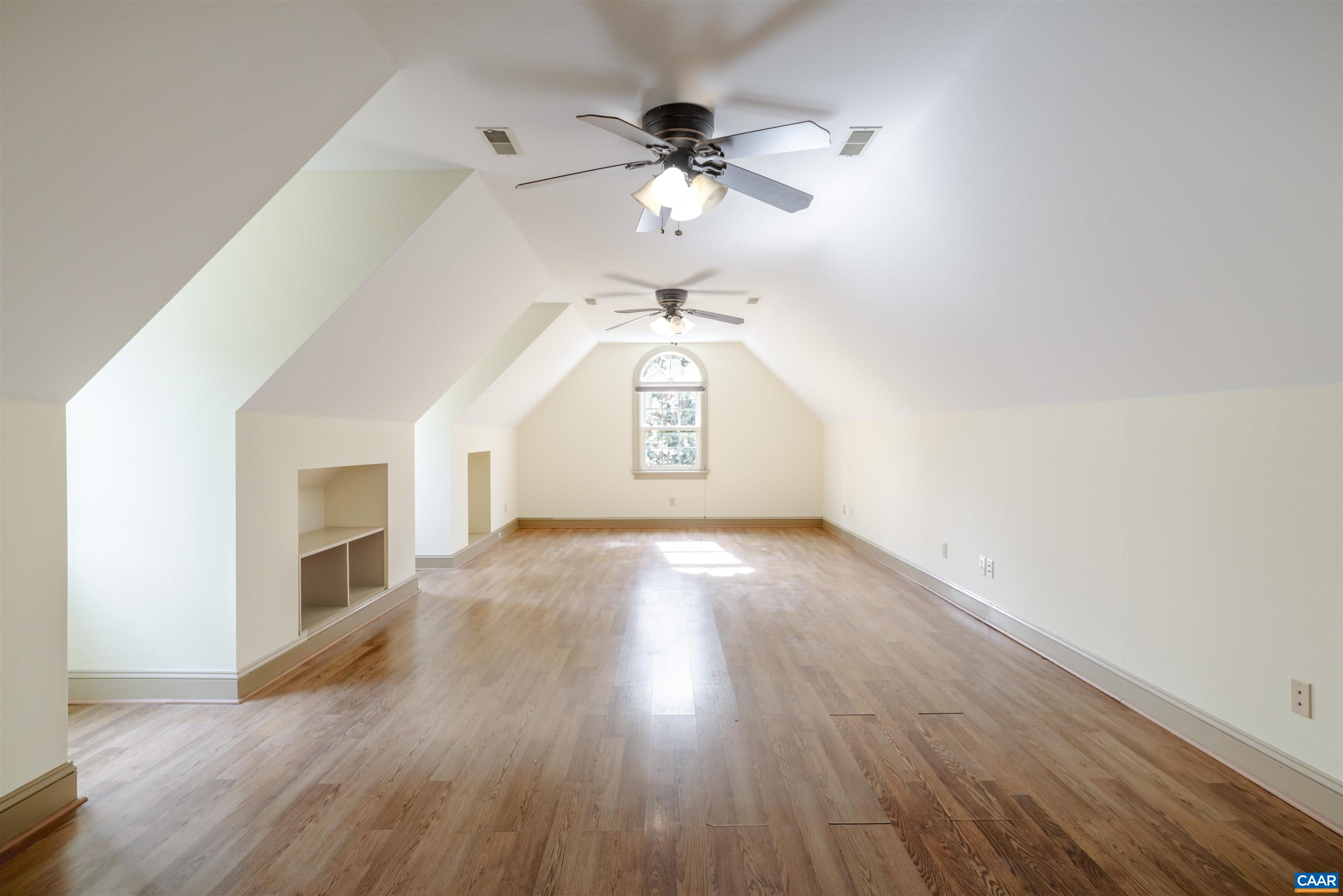3125 Beau Mont Farm Road Charlottesville, VA 22901 - Photo 52 of 74 a view of a livingroom with wooden floor a ceiling fan and windows