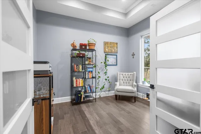 a living room with furniture and a book shelf