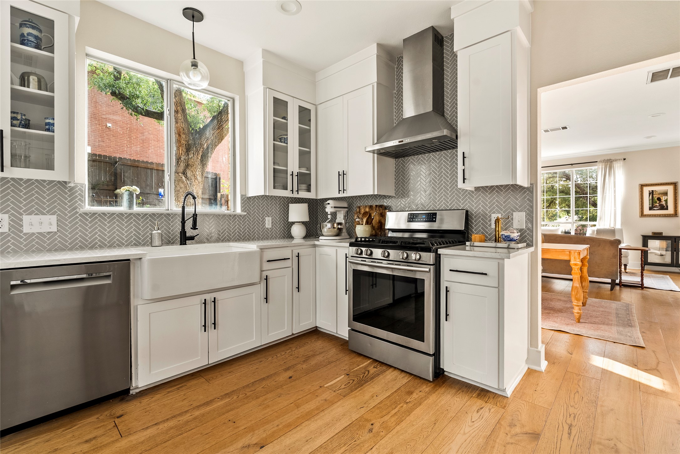 6803 Breezy Pass Austin, TX 78749 - Photo 18 of 40 a kitchen with stainless steel appliances a sink cabinets and wooden floor