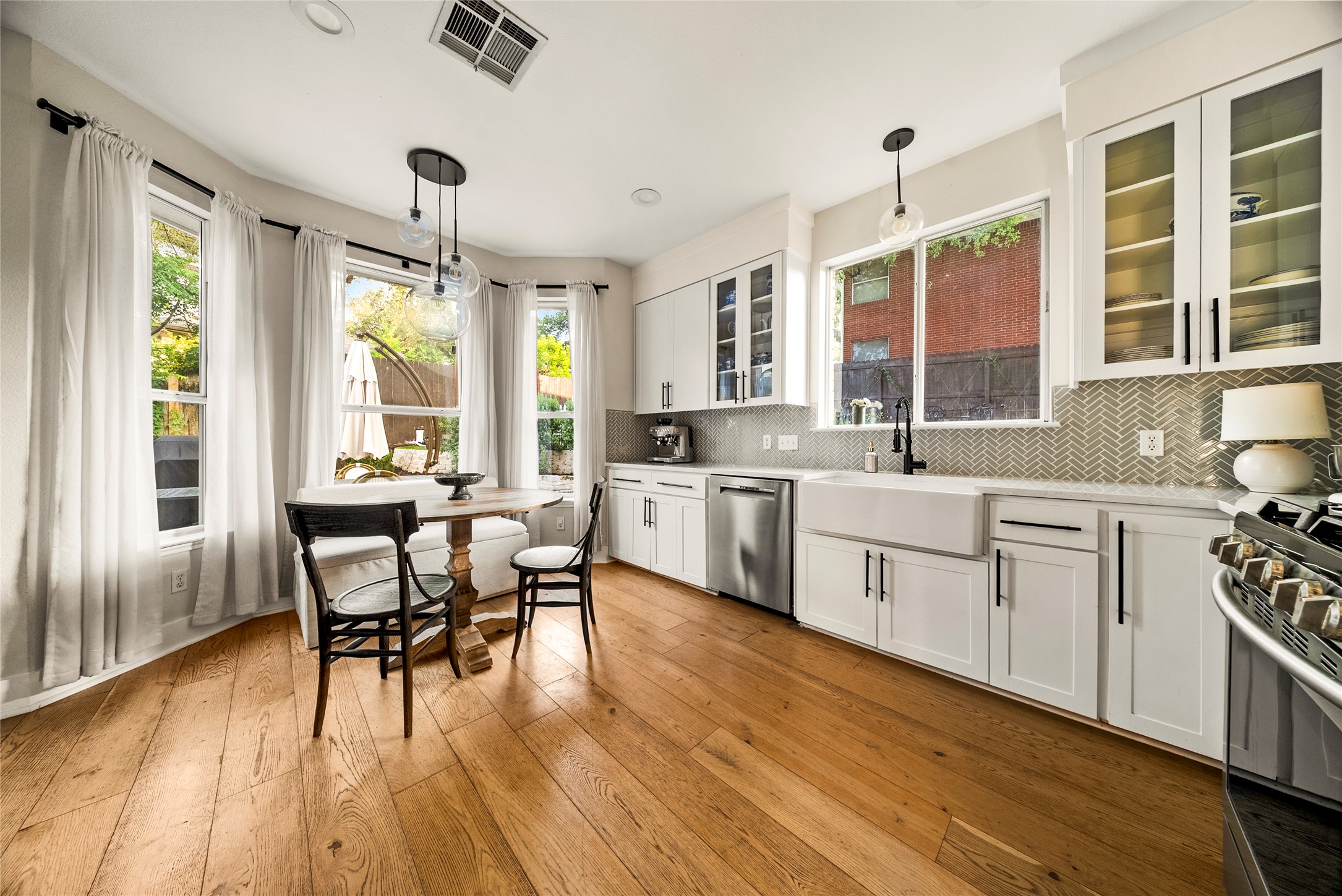 6803 Breezy Pass Austin, TX 78749 - Photo 2 of 40 a kitchen with stainless steel appliances a dining table chairs stove and sink