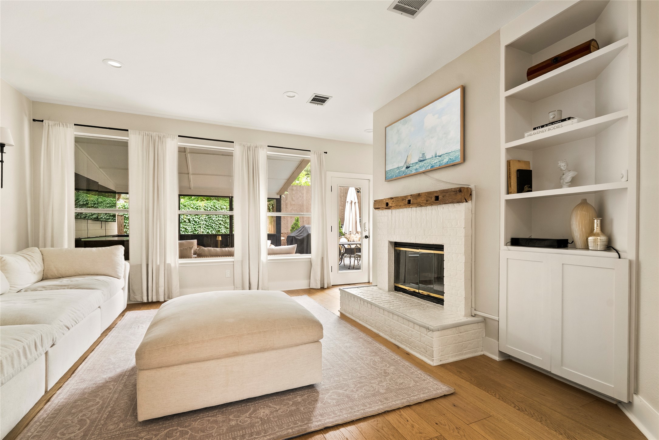 6803 Breezy Pass Austin, TX 78749 - Photo 3 of 40 a spacious bedroom with a bed a fireplace and a large window