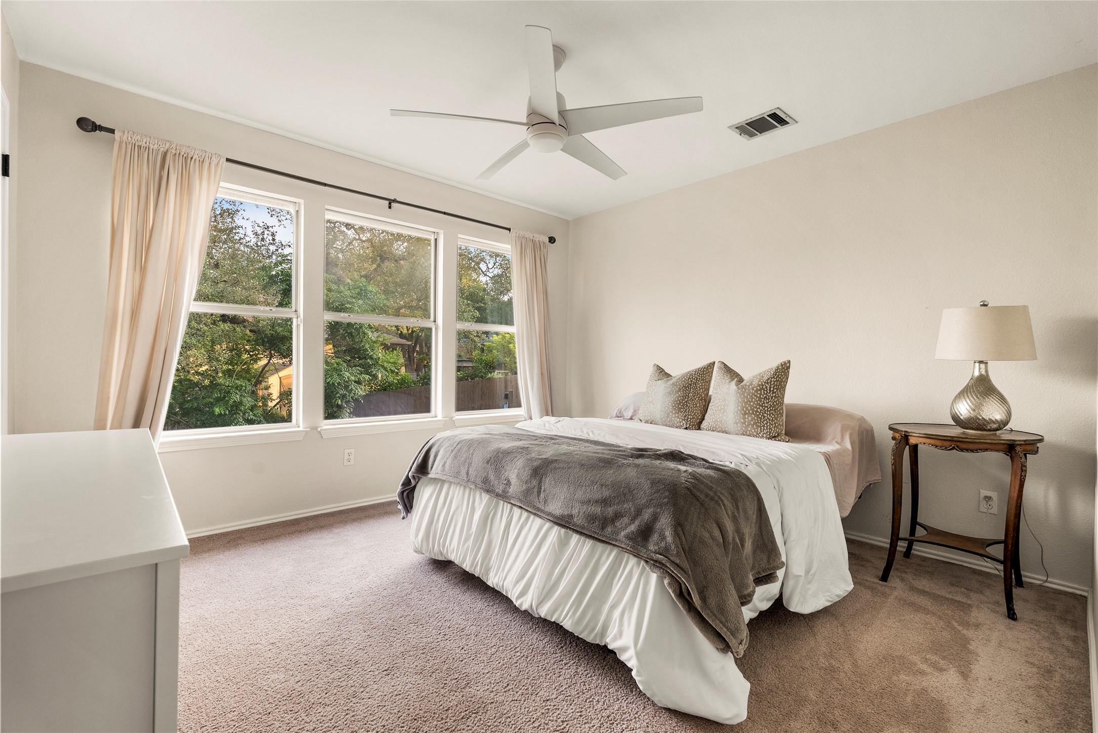 6803 Breezy Pass Austin, TX 78749 - Photo 32 of 40 a spacious bedroom with a bed and a large window
