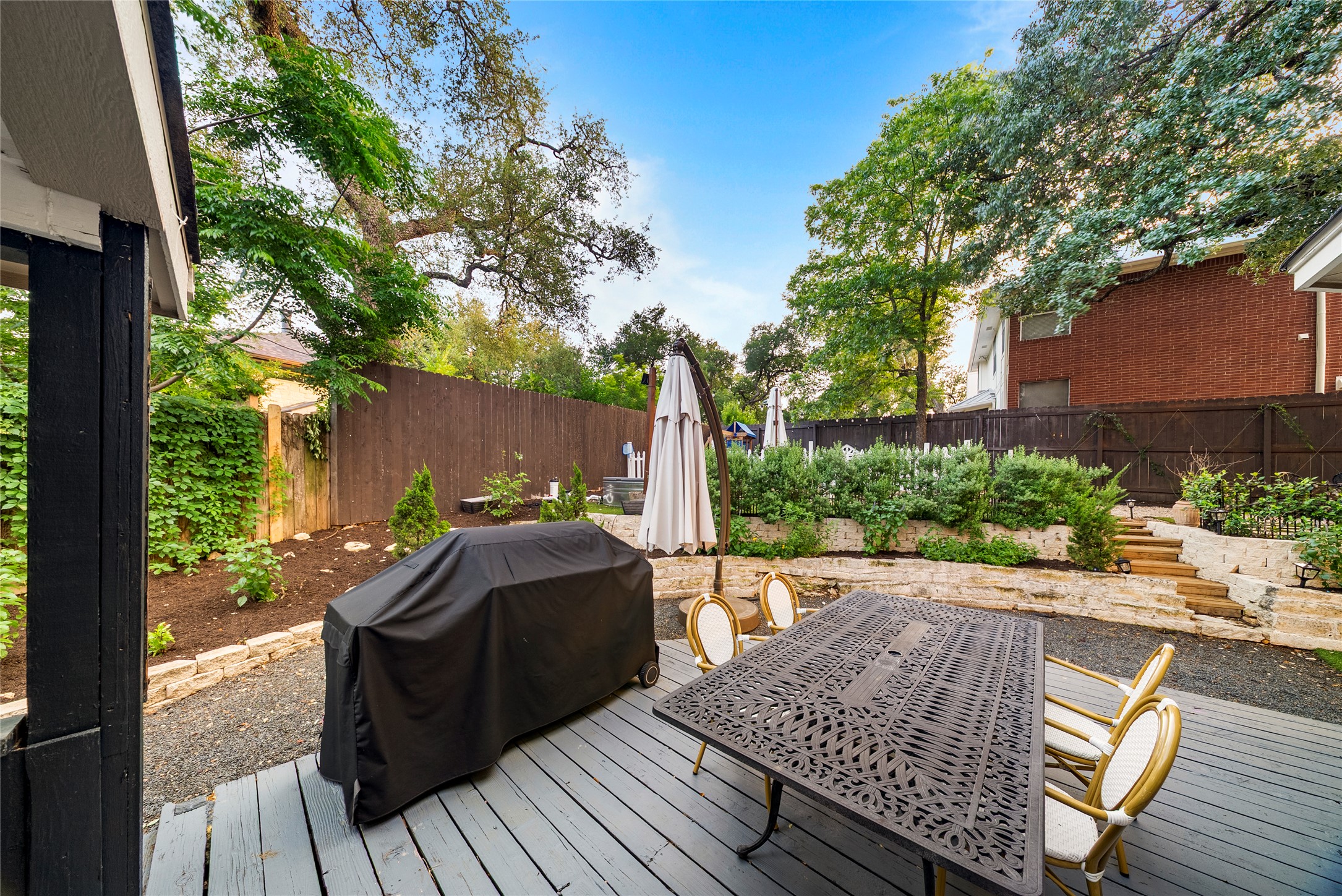 6803 Breezy Pass Austin, TX 78749 - Photo 34 of 40 a view of a wooden deck with table and chairs a barbeque with wooden floor and fence