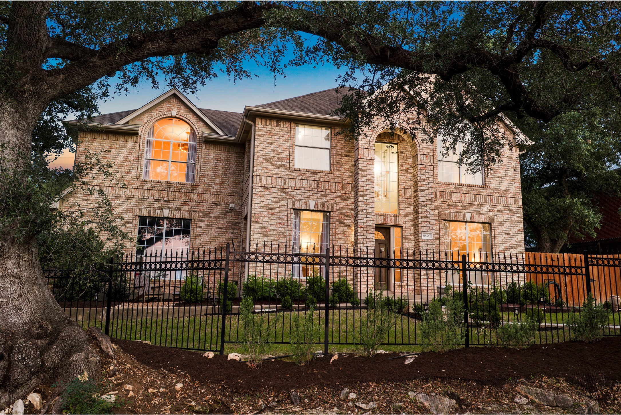 6803 Breezy Pass Austin, TX 78749 - Photo 9 of 40 a view of a brick house next to a yard