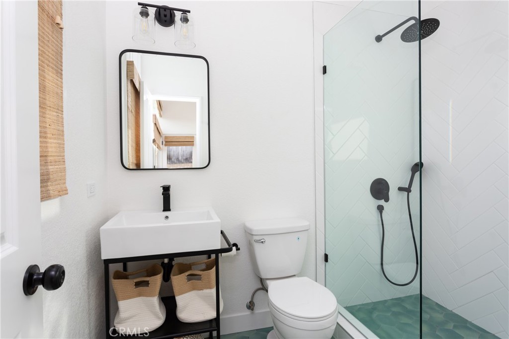 363 Ruby Street Laguna Beach, CA 92651 - Photo 11 of 25 a bathroom with a toilet sink vanity and mirror
