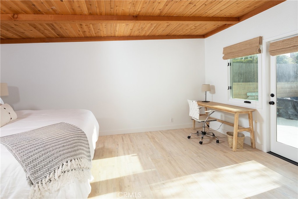 363 Ruby Street Laguna Beach, CA 92651 - Photo 15 of 25 a bedroom with a bed and a table