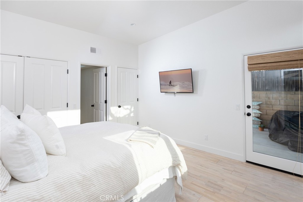 363 Ruby Street Laguna Beach, CA 92651 - Photo 17 of 25 a bedroom with a bed and a mirror
