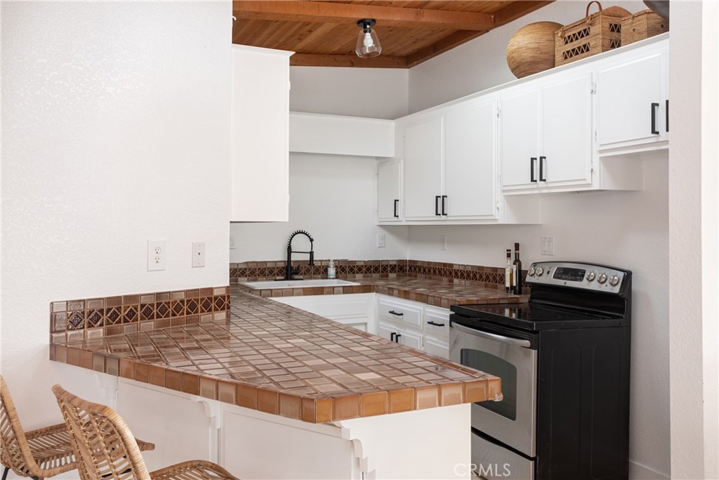 363 Ruby Street Laguna Beach, CA 92651 - Photo 8 of 25 a kitchen with granite countertop a stove and a sink