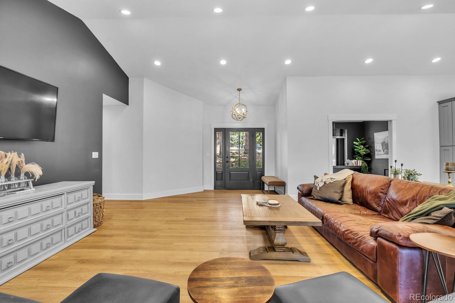 22398 Blue Jay Road Morrison, CO 80465 - Photo 13 of 39 a living room with furniture and a flat screen tv