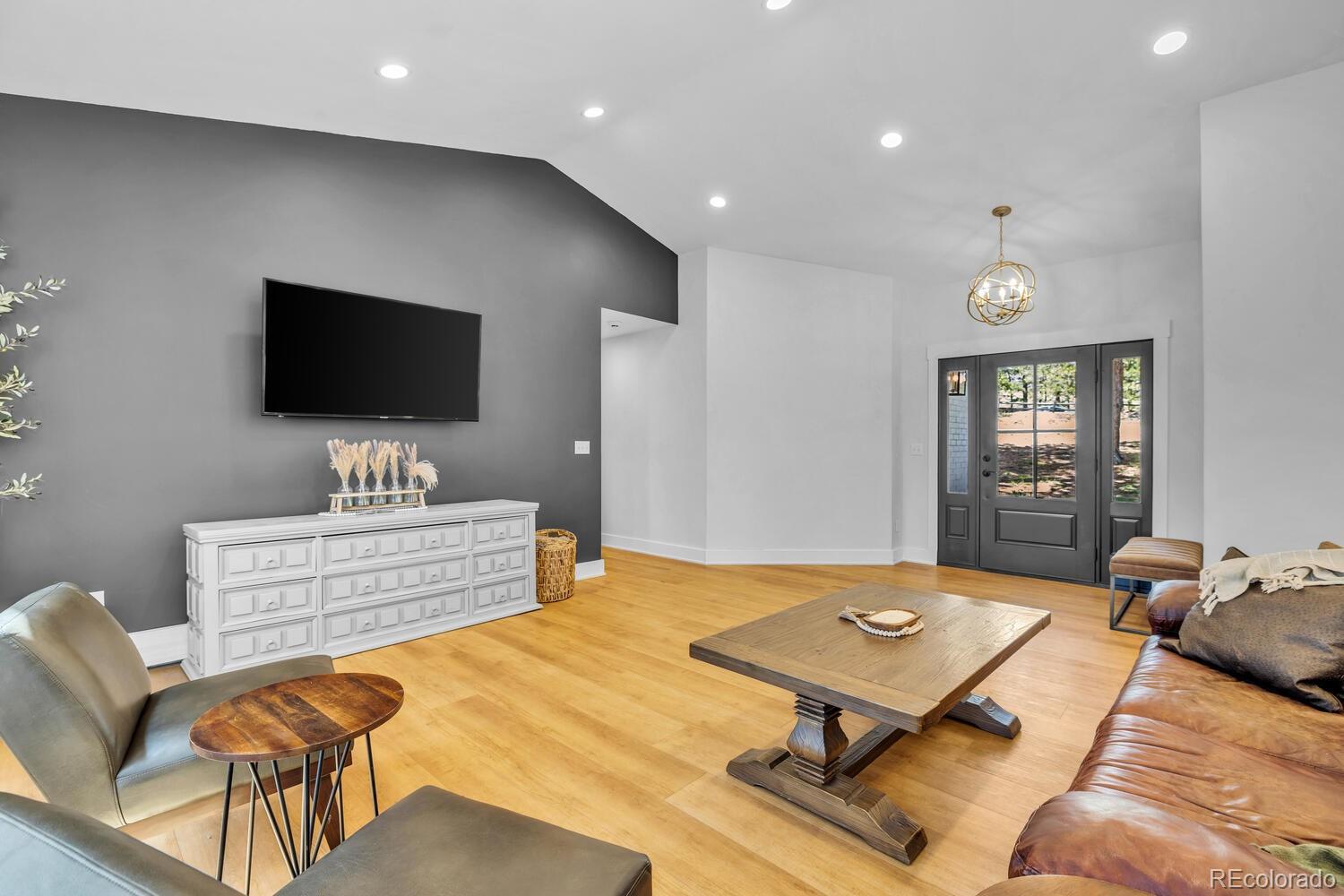 22398 Blue Jay Road Morrison, CO 80465 - Photo 14 of 39 a living room with furniture and a flat screen tv