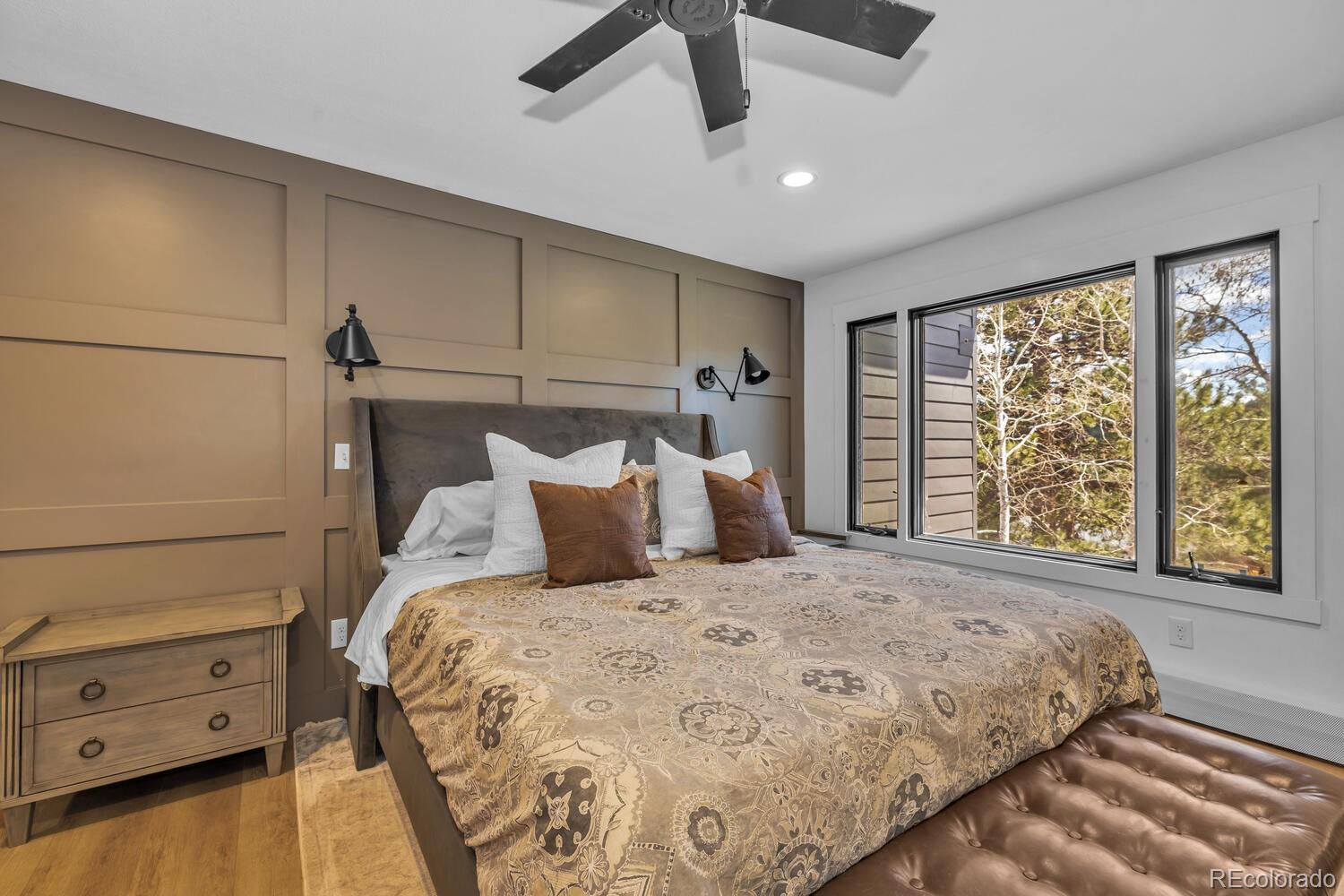 22398 Blue Jay Road Morrison, CO 80465 - Photo 18 of 39 a large bed sitting in a bedroom next to a window