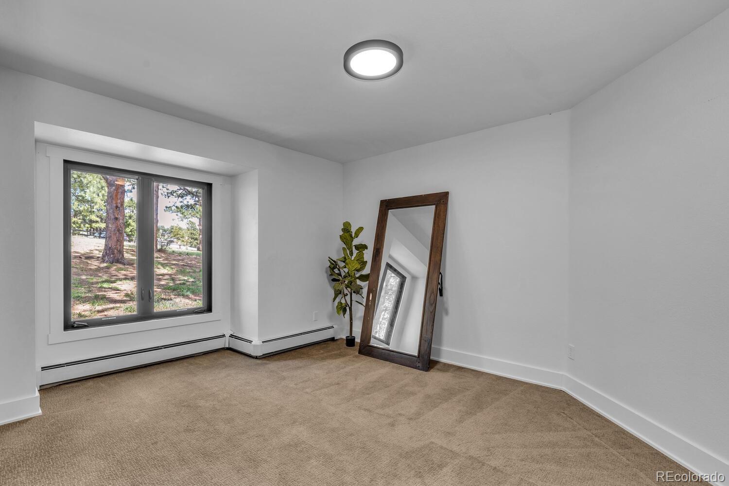 22398 Blue Jay Road Morrison, CO 80465 - Photo 20 of 39 an empty room with windows
