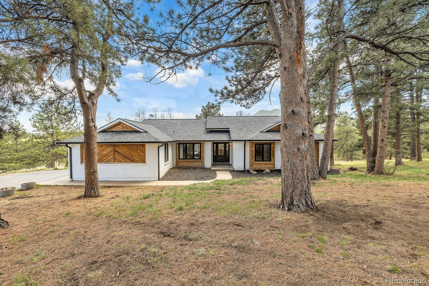 22398 Blue Jay Road Morrison, CO 80465 - Photo 2 of 39 a view of a house with a yard covered in snow