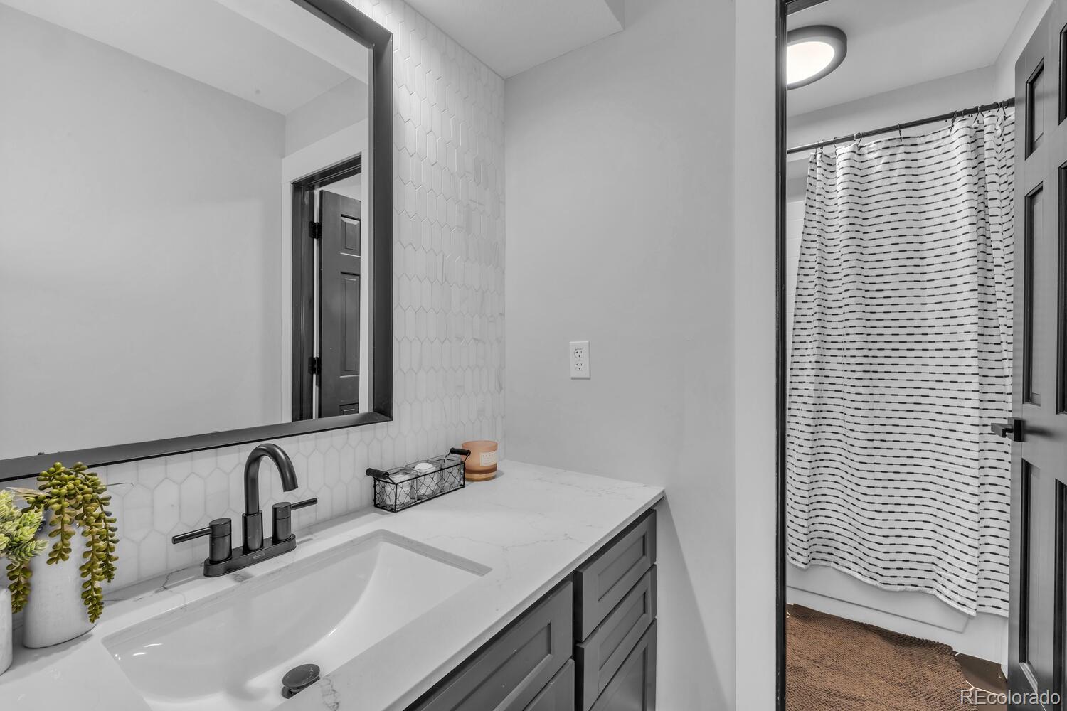 22398 Blue Jay Road Morrison, CO 80465 - Photo 22 of 39 a bathroom with a sink and a mirror