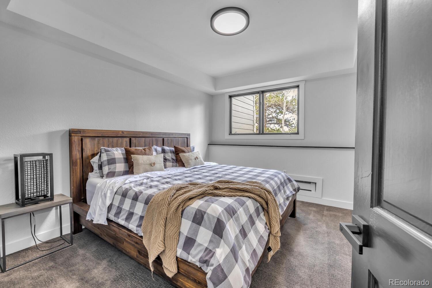 22398 Blue Jay Road Morrison, CO 80465 - Photo 29 of 39 a bedroom with a bed and window