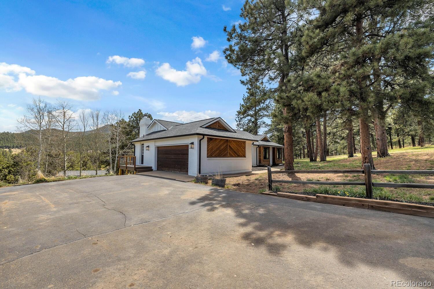 22398 Blue Jay Road Morrison, CO 80465 - Photo 3 of 39 a view of a house with a yard